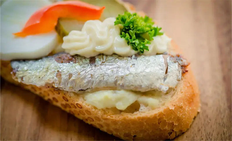 Drone view of a sailboat anchored in a crystal-clear cove near Andratx, Mallorca