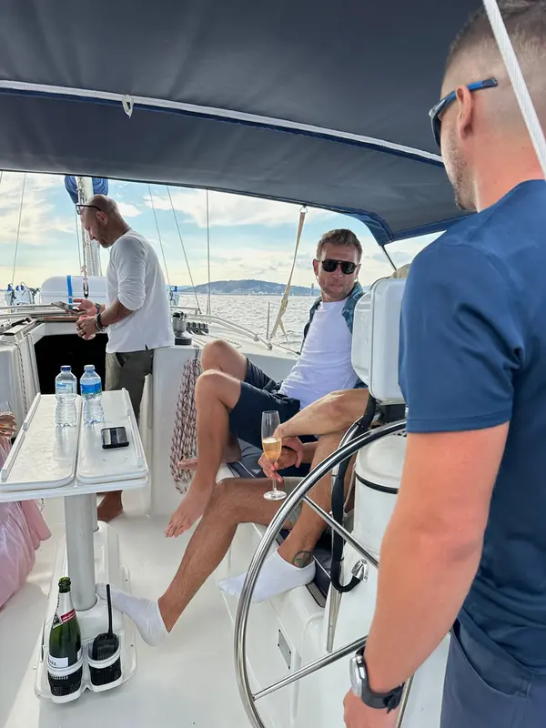 Guests jumping into crystal-clear Mediterranean water from the yacht's deck