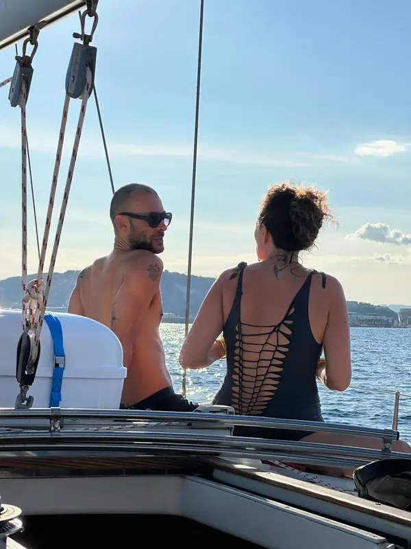 Guests relaxing and sunbathing on the deck of Alegria sailing yacht in Mallorca